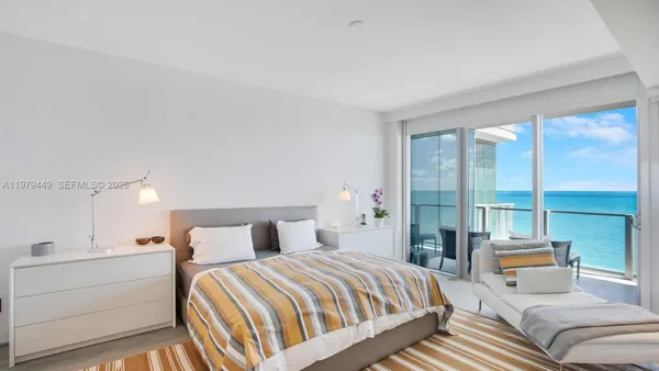 a bedroom with a bed and glass window