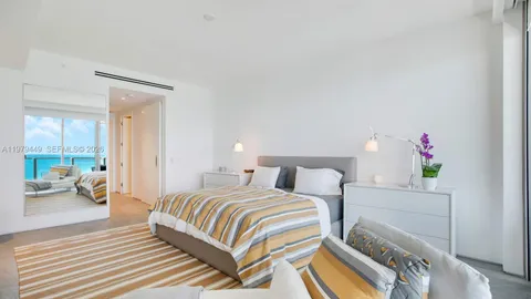 a bedroom with a bed and a couch