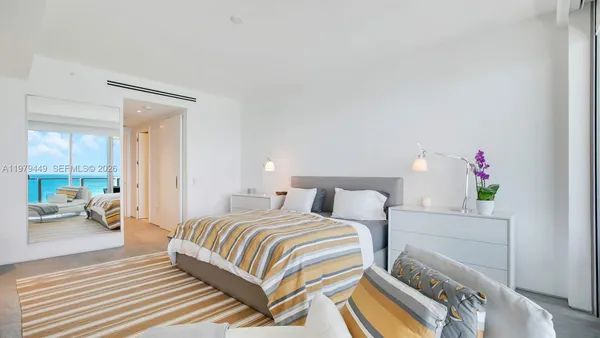 a bedroom with a bed and a couch