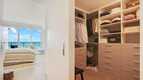 a view of walk in closet and bedroom