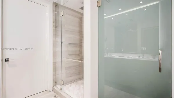 a bathroom with a glass shower door