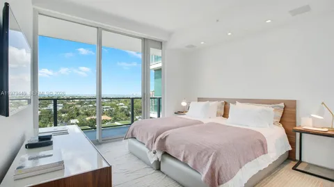 a bedroom with a large bed and a large window