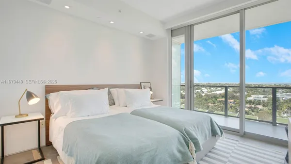 a bedroom with a large bed and a large window