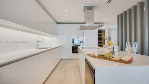 a large kitchen with a large counter top appliances and cabinets
