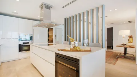 a kitchen with a sink cabinets and wooden floor