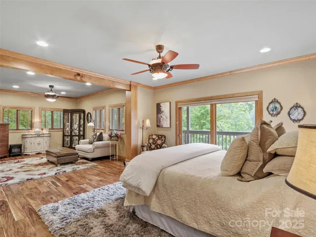 a spacious bedroom with a bed and glass walk in closet