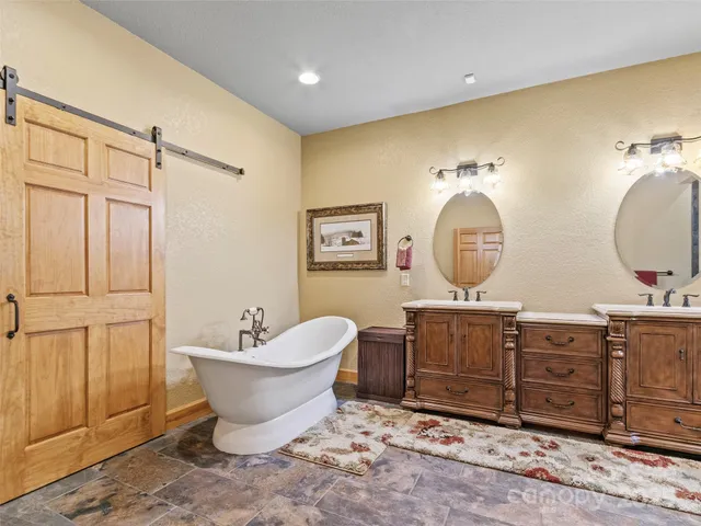 a living room with furniture a mirror and lamp