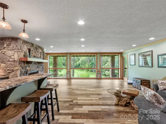 a living room with furniture and large windows
