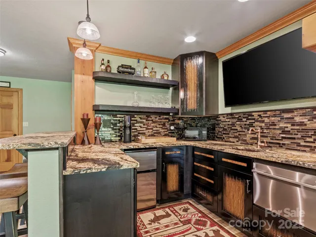 a kitchen with stainless steel appliances granite countertop a sink and a stove