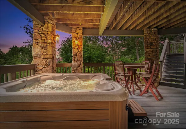 a roof deck with table and chairs and potted plants