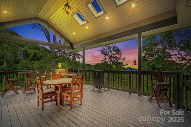 a view of a chairs and table on the wooden deck