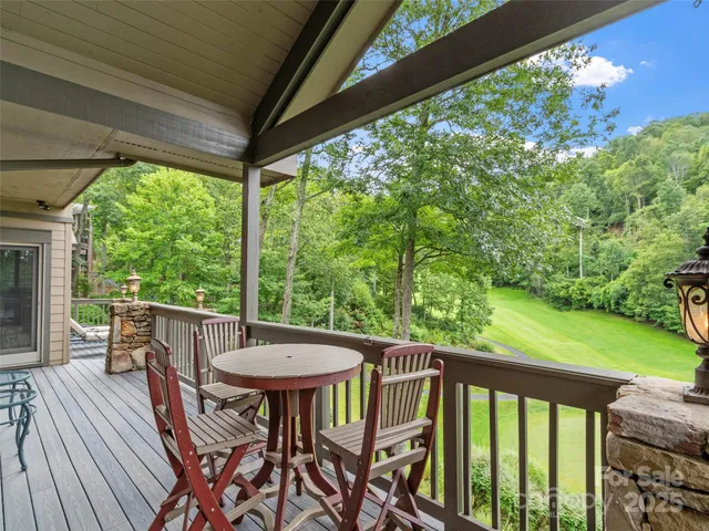 a view of a balcony with furniture and a yard