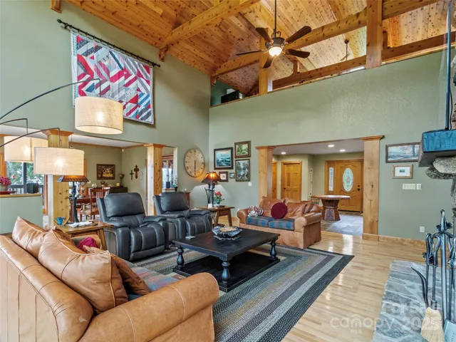 a living room with furniture kitchen view and a large window