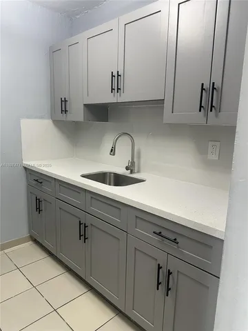 a kitchen with cabinets and a sink