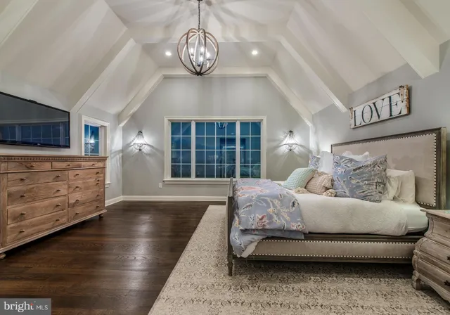 a dining hall with stainless steel appliances granite countertop a stove and cabinets with wooden floor