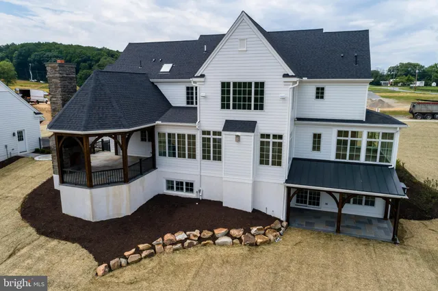 a view of a porch with furniture and backyard of house