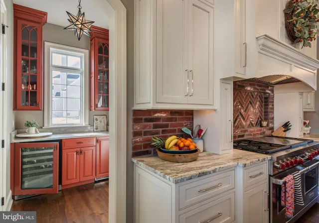 a kitchen with a stove and wooden floor