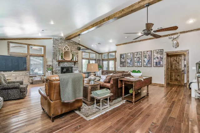 a living room with furniture and a floor to ceiling window