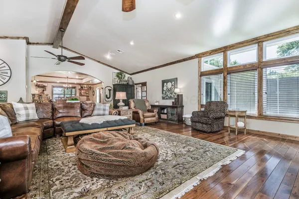a living room with furniture and a floor to ceiling window