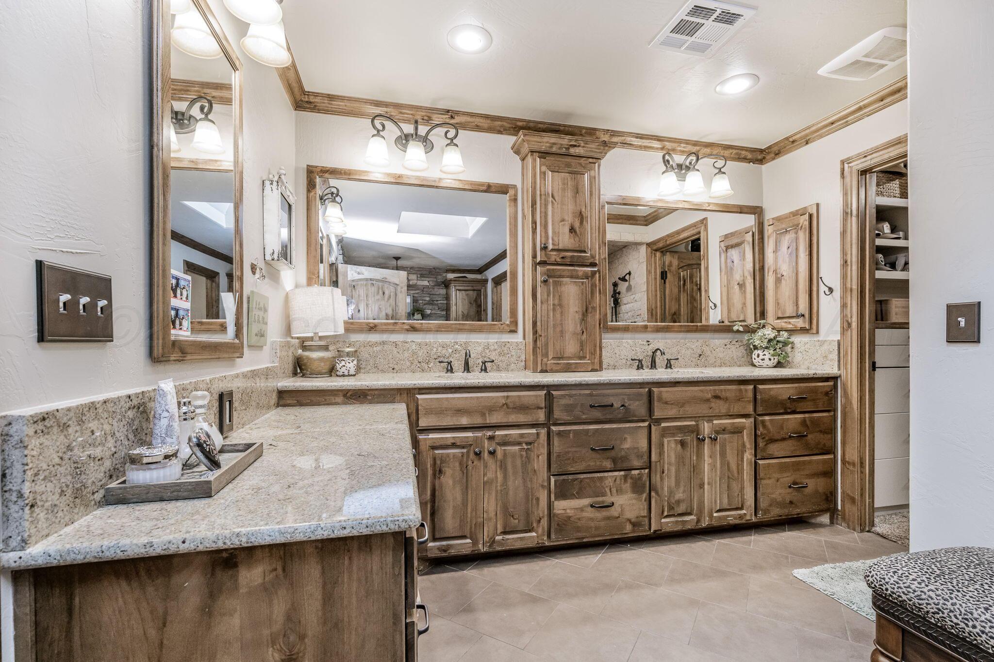 100 Thomas Lane Wheeler, TX 79096 - Photo 17 of 50 a bathroom with double vanity and a mirror