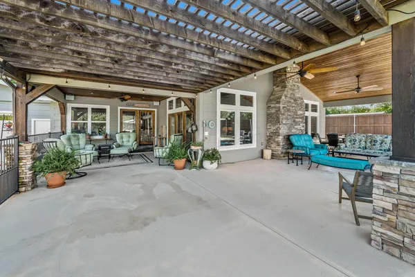 a living room with furniture and potted plants