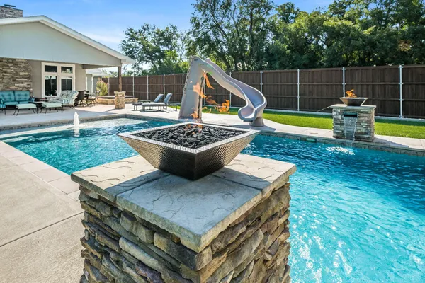 a view of a backyard with sitting area