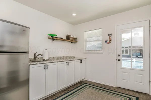 a view of a hardwood floor and white cabinet