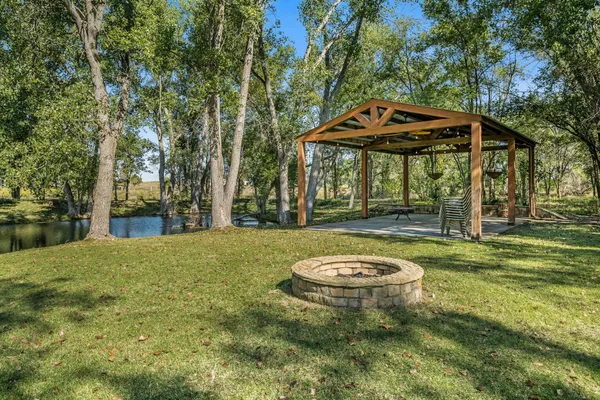 a backyard of a house with table and chairs