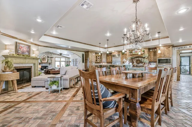 a view of a dining room with furniture a chandelier and wooden floor
