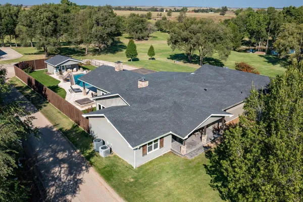 an aerial view of a house with yard swimming pool and mountain view