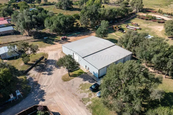 an aerial view of a house with a yard