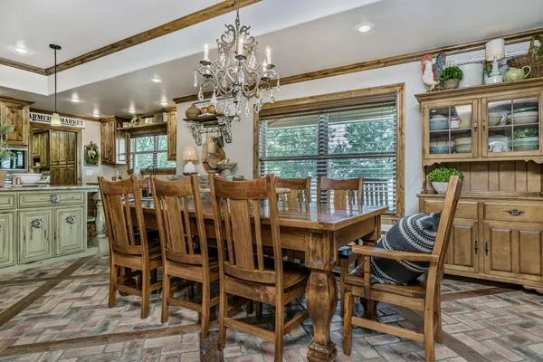 a view of a dining room with furniture wooden floor and chandelier