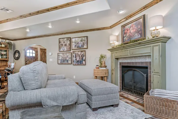 a living room with furniture and a fireplace