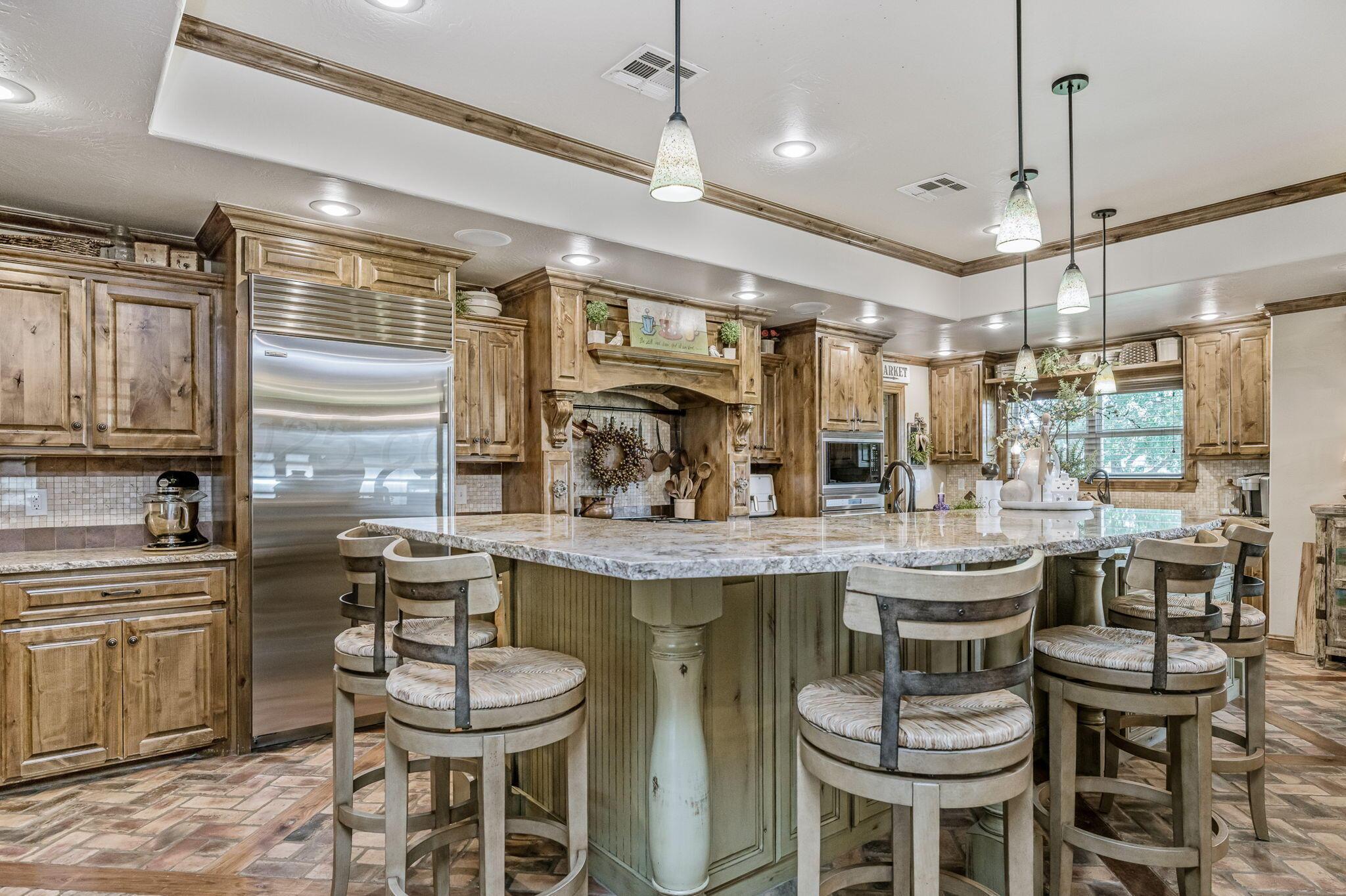 100 Thomas Lane Wheeler, TX 79096 - Photo 7 of 50 a kitchen with a dining table chairs cabinets and stainless steel appliances