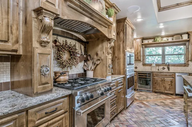 a kitchen with stainless steel appliances granite countertop a sink and stove