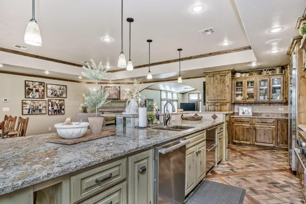 a kitchen with stainless steel appliances granite countertop a sink and stove