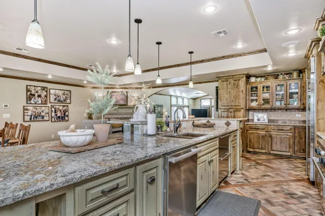 a kitchen with stainless steel appliances granite countertop a stove a sink and a microwave