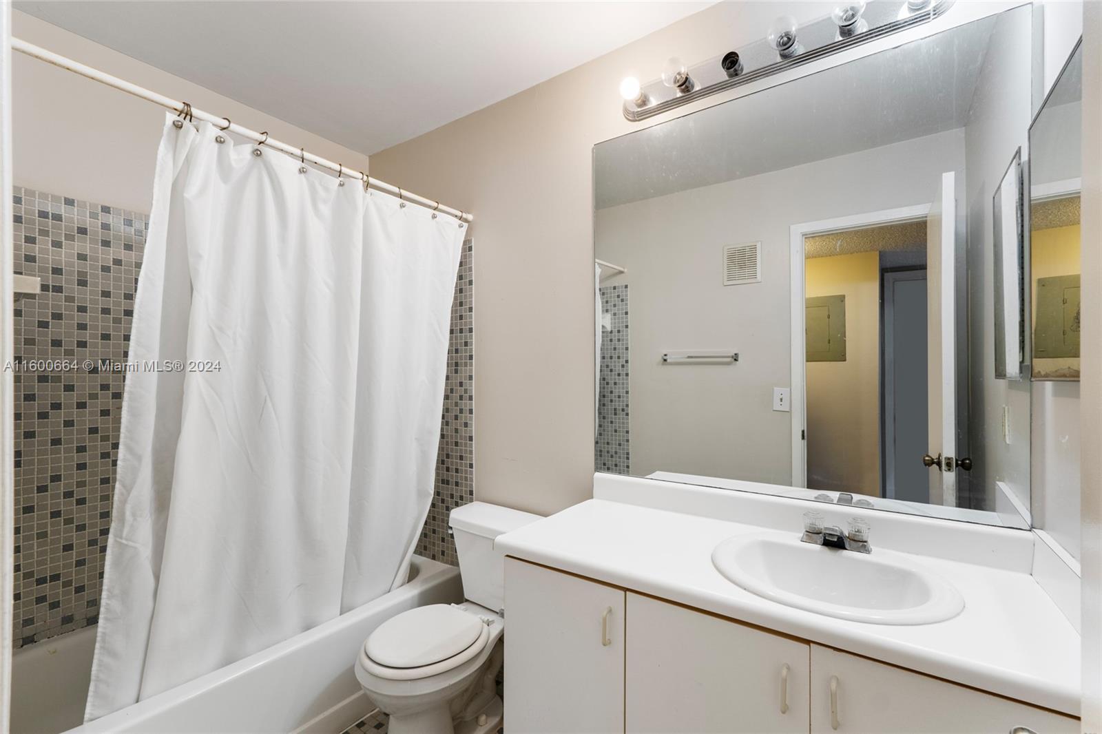 9723 Hammocks Boulevard, Unit 202 Miami, FL 33196 - Photo 11 of 15 a bathroom with a sink and a mirror