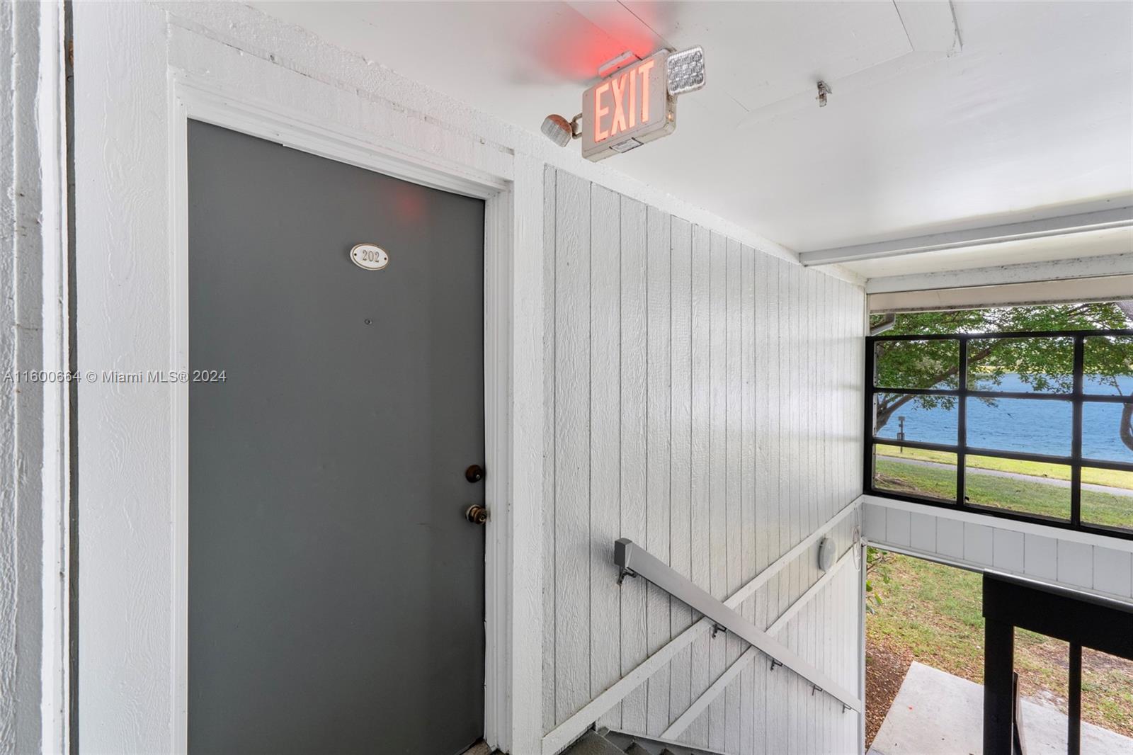 9723 Hammocks Boulevard, Unit 202 Miami, FL 33196 - Photo 13 of 15 a view of a hallway with window