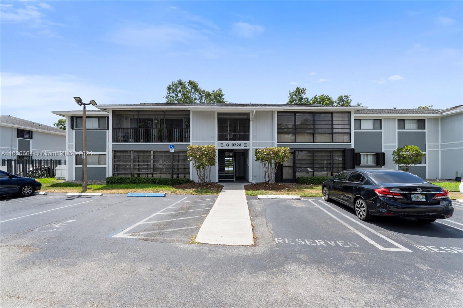 9723 Hammocks Boulevard, Unit 202 Miami, FL 33196 - Photo 15 of 15 a car parked in front of a house