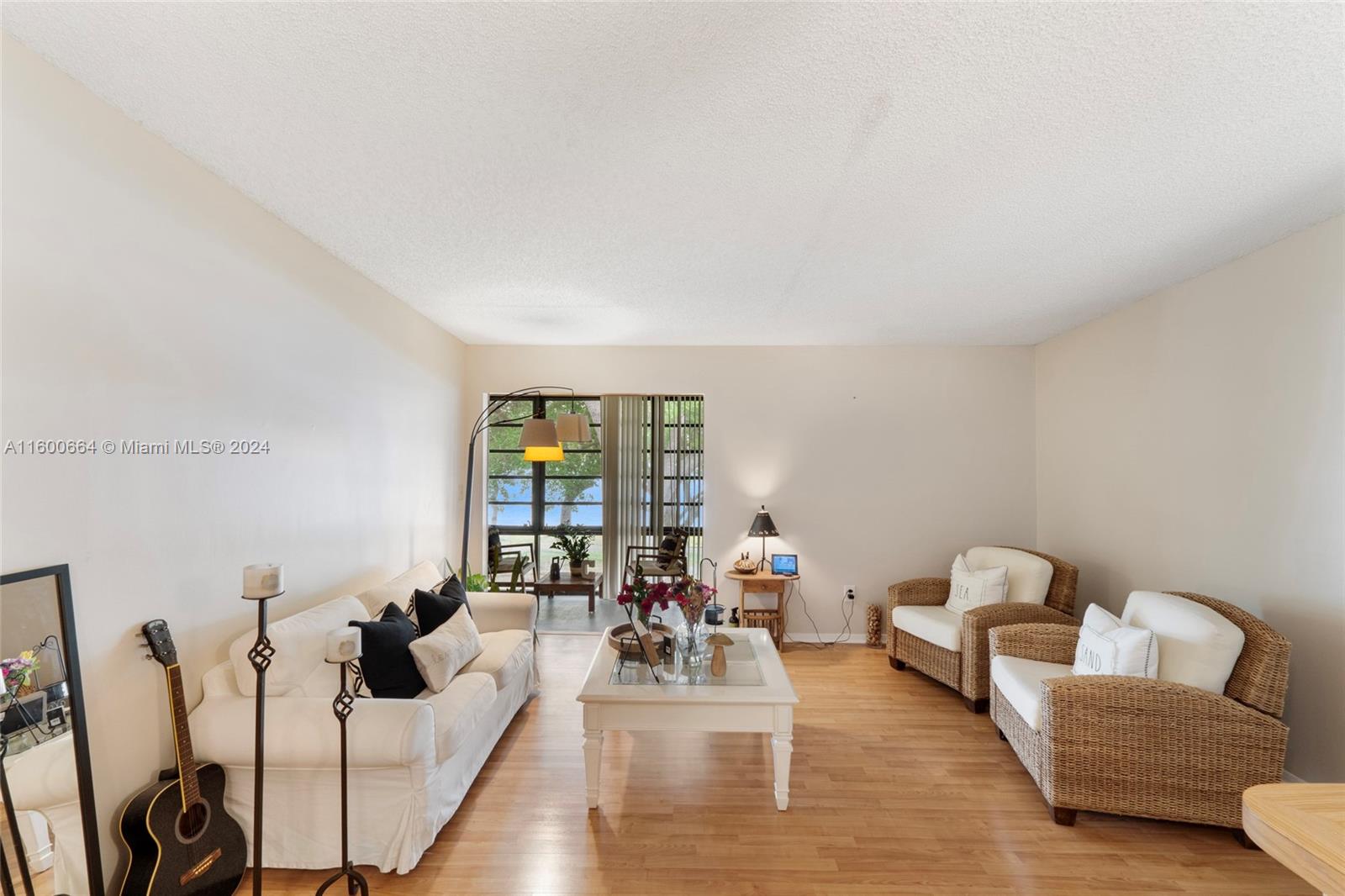 9723 Hammocks Boulevard, Unit 202 Miami, FL 33196 - Photo 2 of 15 a living room with furniture and wooden floor