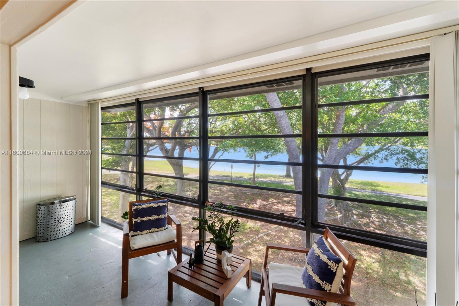 9723 Hammocks Boulevard, Unit 202 Miami, FL 33196 - Photo 5 of 15 a view of a living room with a large window and wooden floor