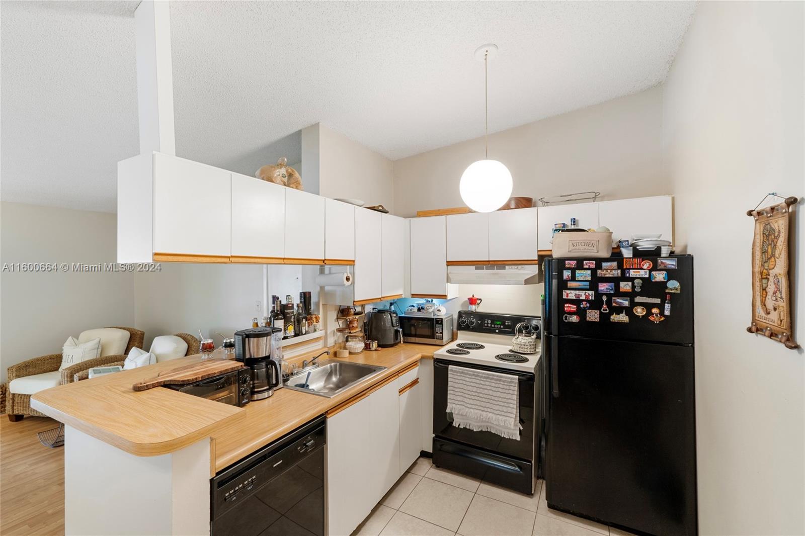 9723 Hammocks Boulevard, Unit 202 Miami, FL 33196 - Photo 7 of 15 a kitchen with a sink a stove and refrigerator