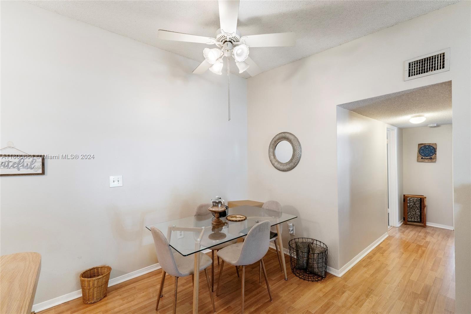 9723 Hammocks Boulevard, Unit 202 Miami, FL 33196 - Photo 8 of 15 a view of a dining room with furniture and wooden floor