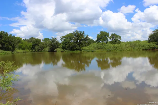 a view of a lake with houses in the back