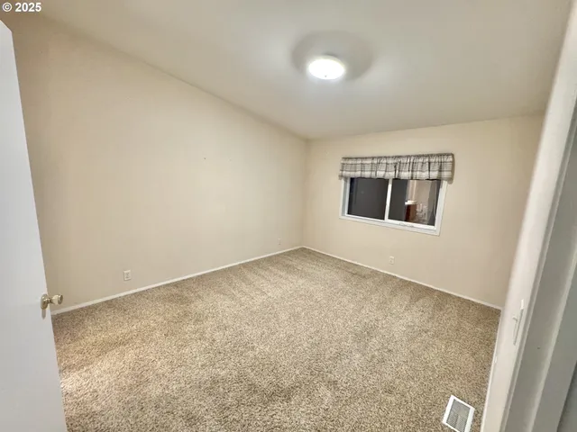 an empty room with a windows