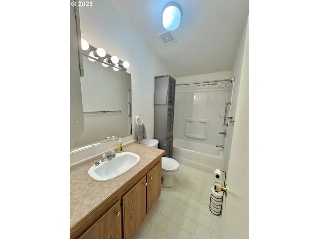 a bathroom with a sink double vanity granite and a mirror