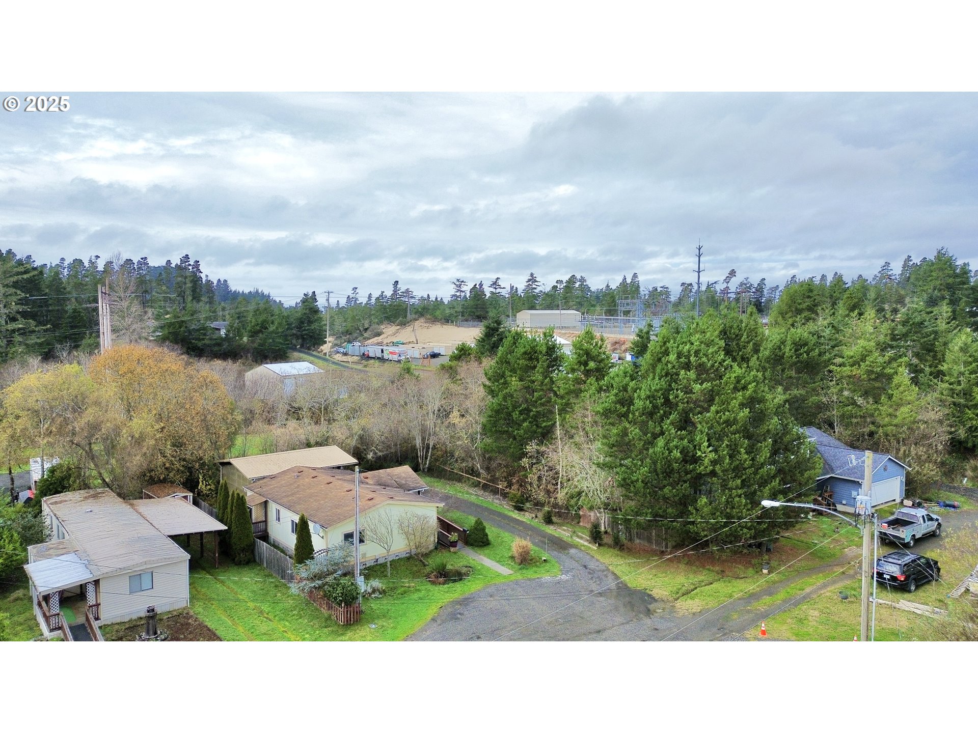 185 North 3rd Street Lakeside, OR 97449 - Photo 36 of 45 a aerial view of a house with a yard and lake view