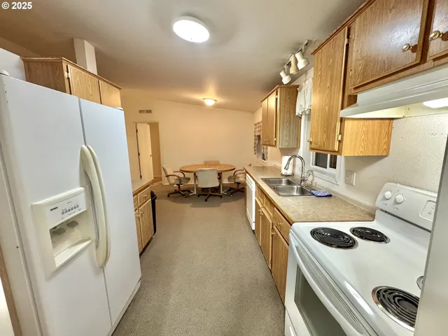 a kitchen with a refrigerator a sink a stove and a refrigerator