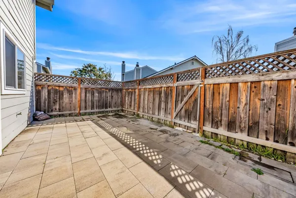 a view of backyard with wooden fence